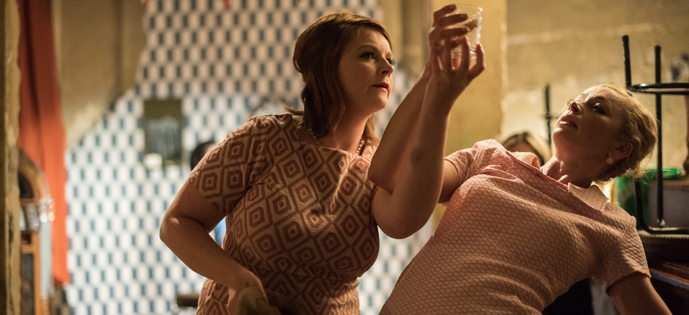 Two women both holding a glass